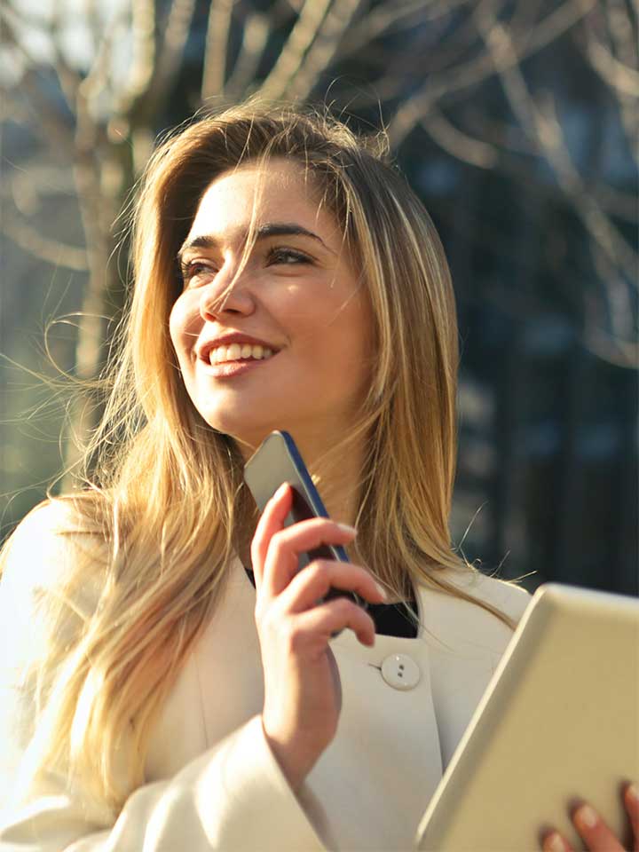 Woman holding a phone and mobile tablet